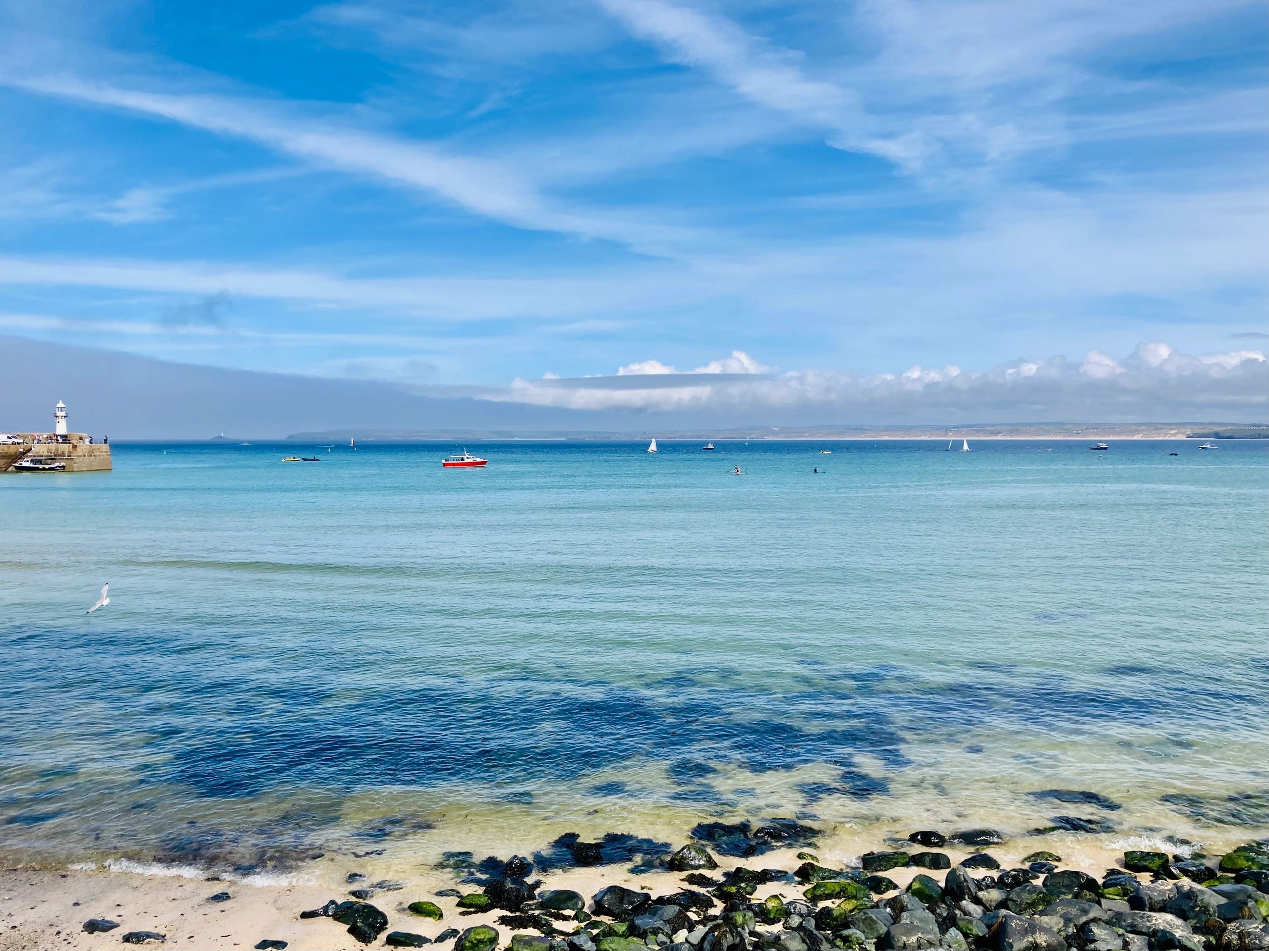 St Ives, a wide sandy beach and sheltered harbour with boats