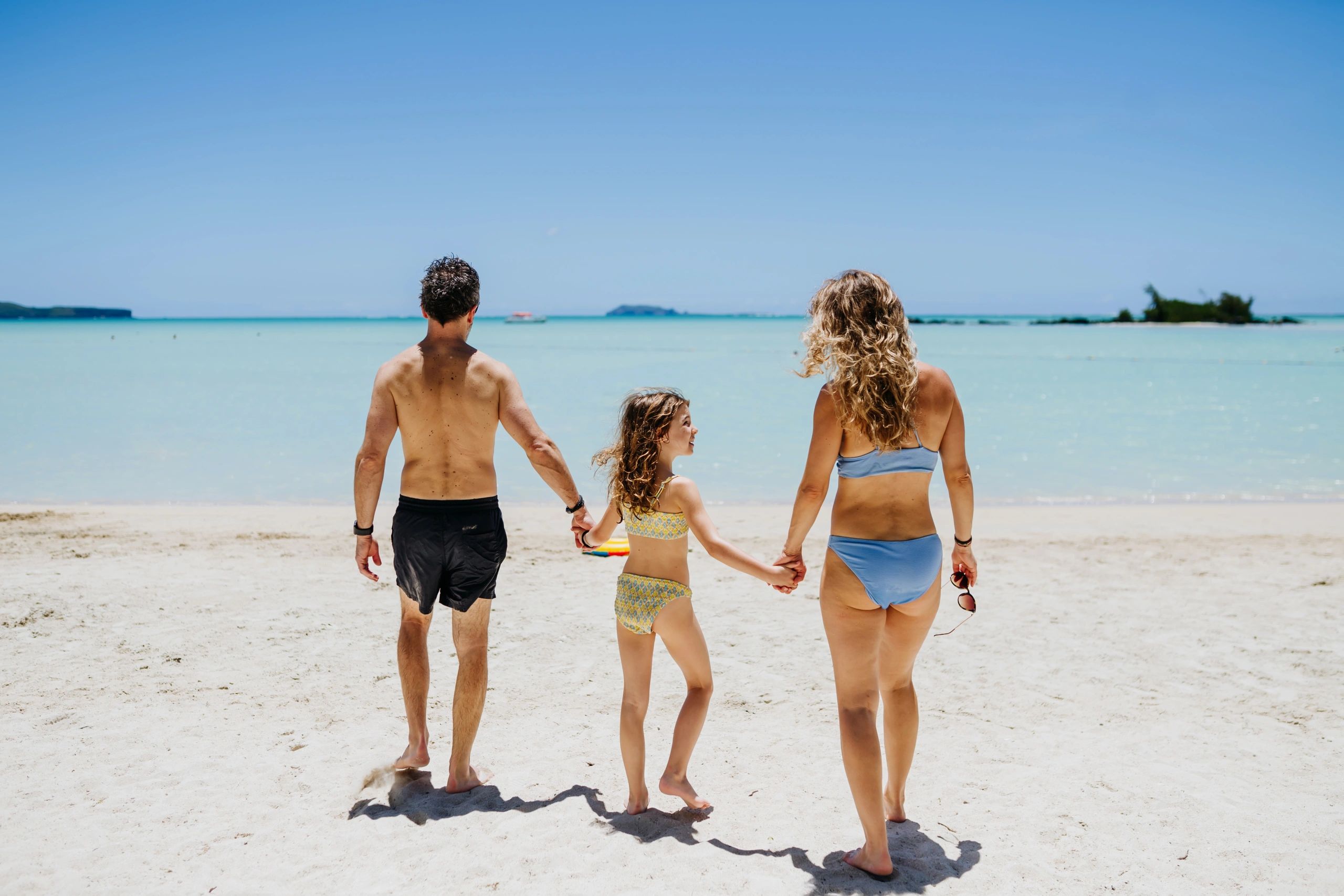 Family walking on a tropical beach