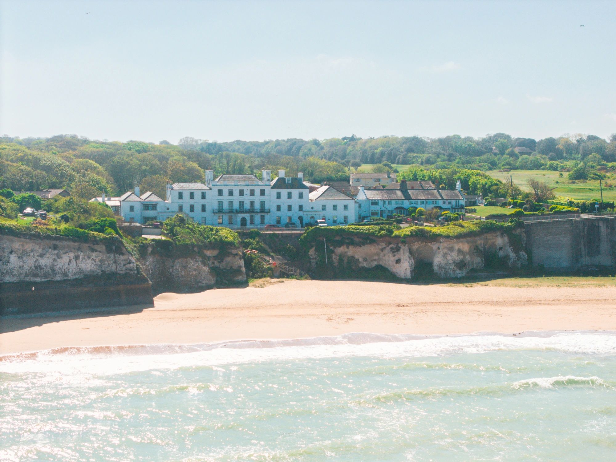 English coastline with resort buildings overlooking a sandy beach