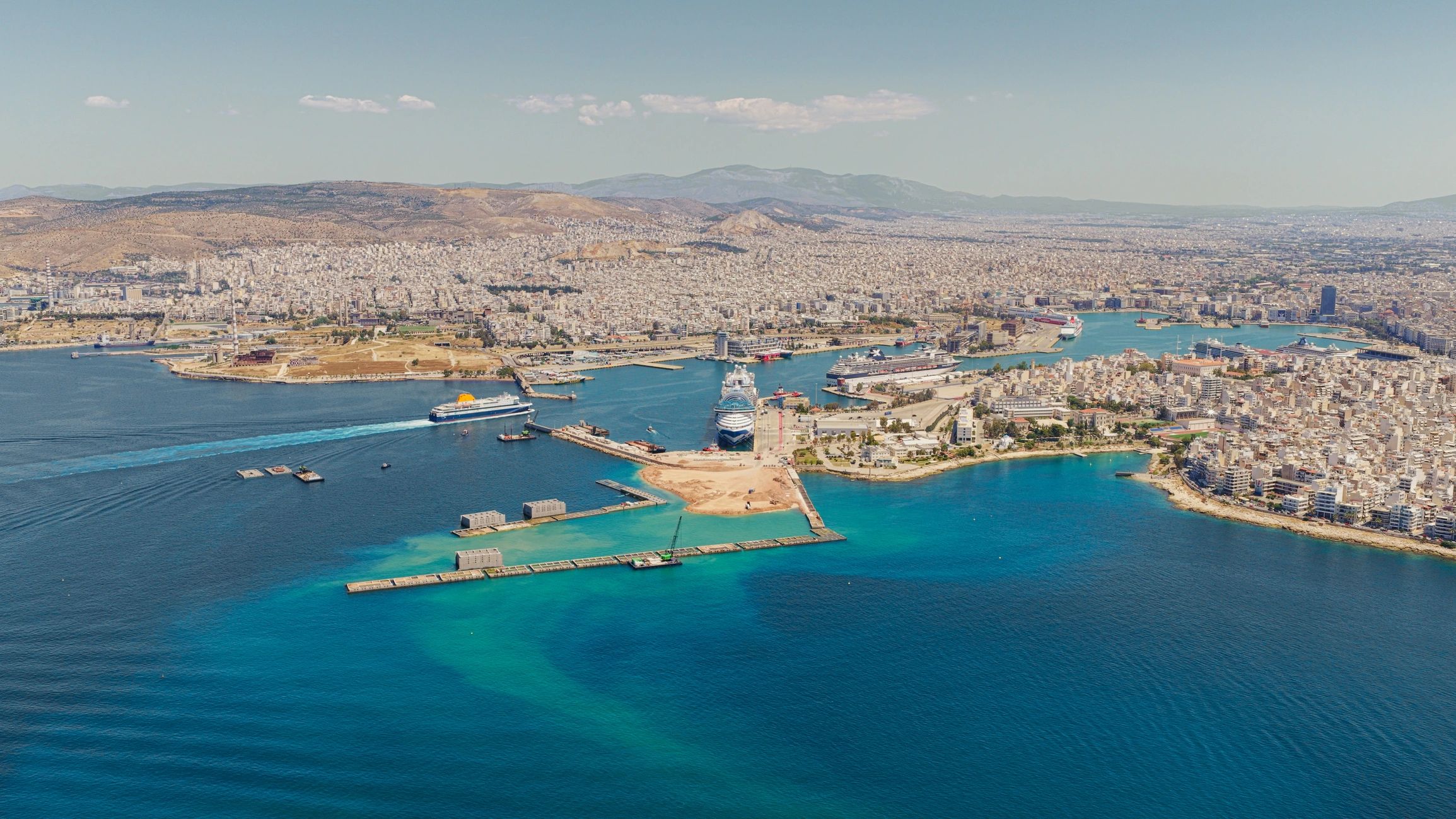 Piraeus port with ships and cityscape aerial view