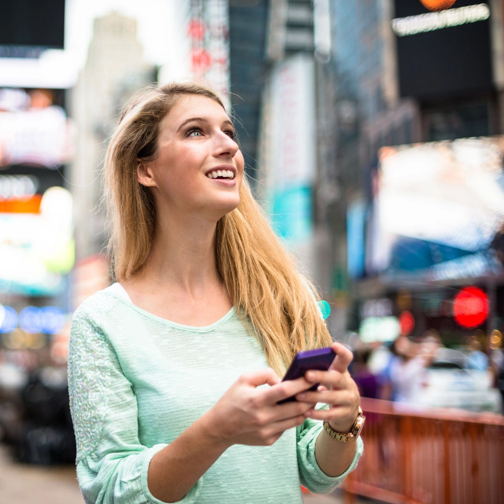 Happy traveller on the phone in a city setting